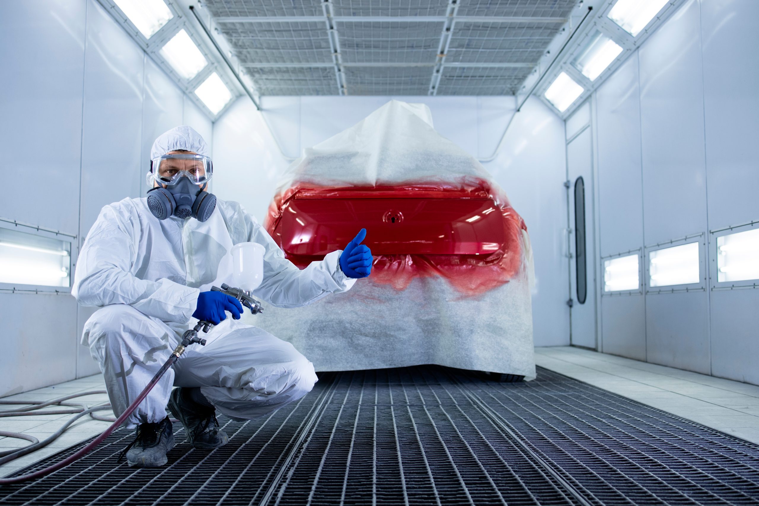 Technician repairing scratched car paintwork in Stoke-on-Trent